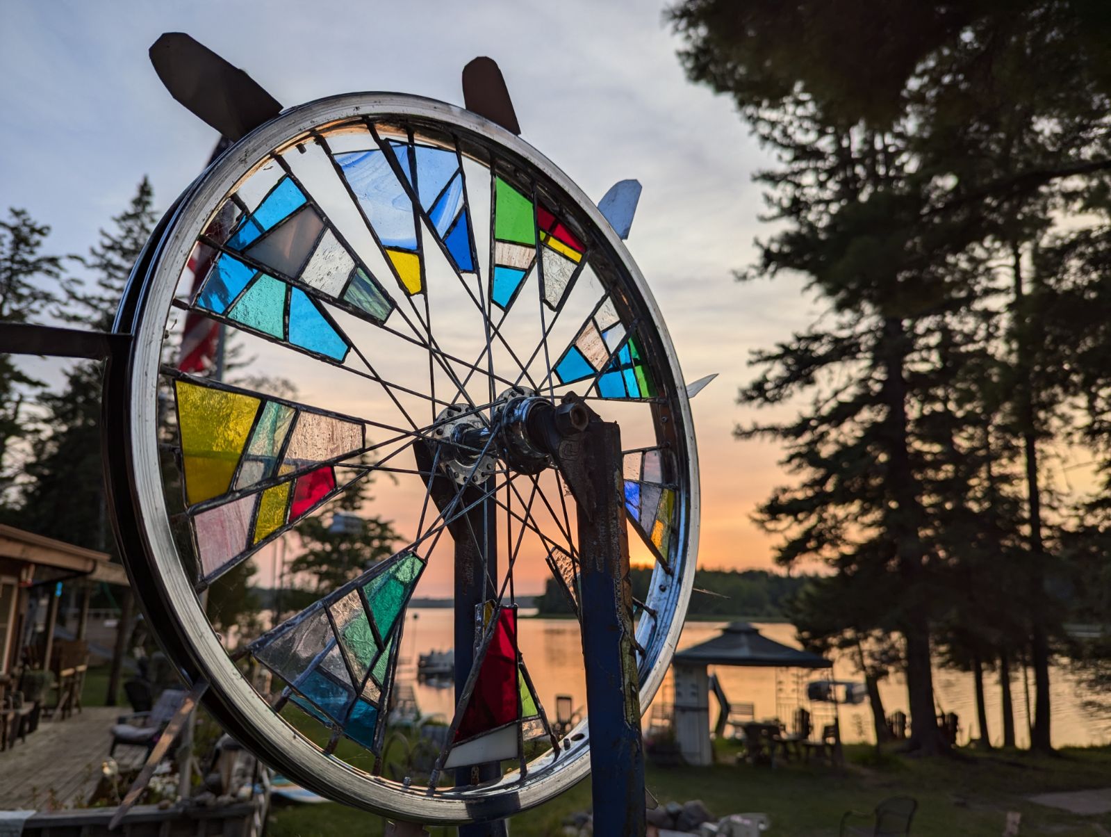 Glass art on a bike wheel at sunset on the lake