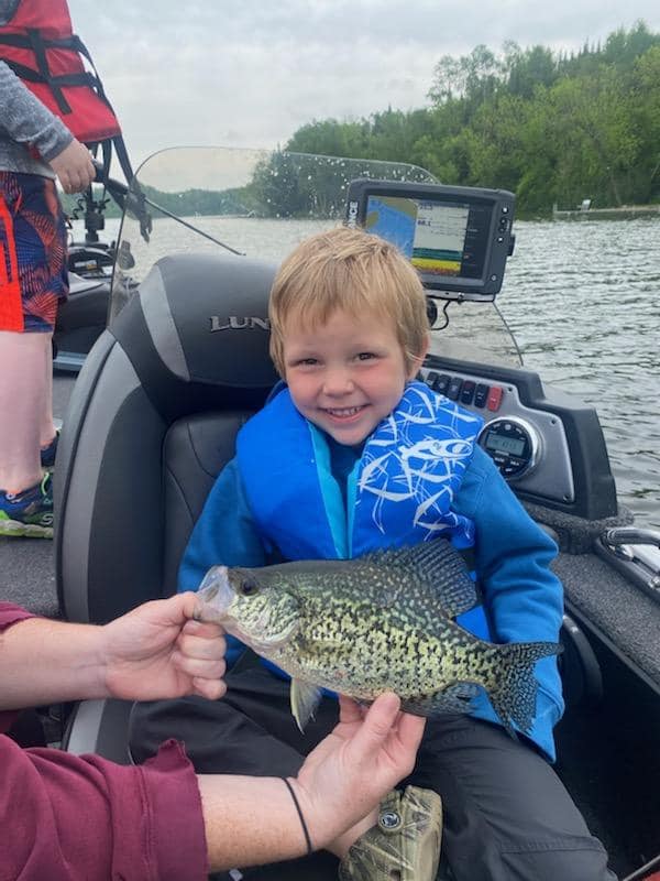 Little boy smiling with large crappie