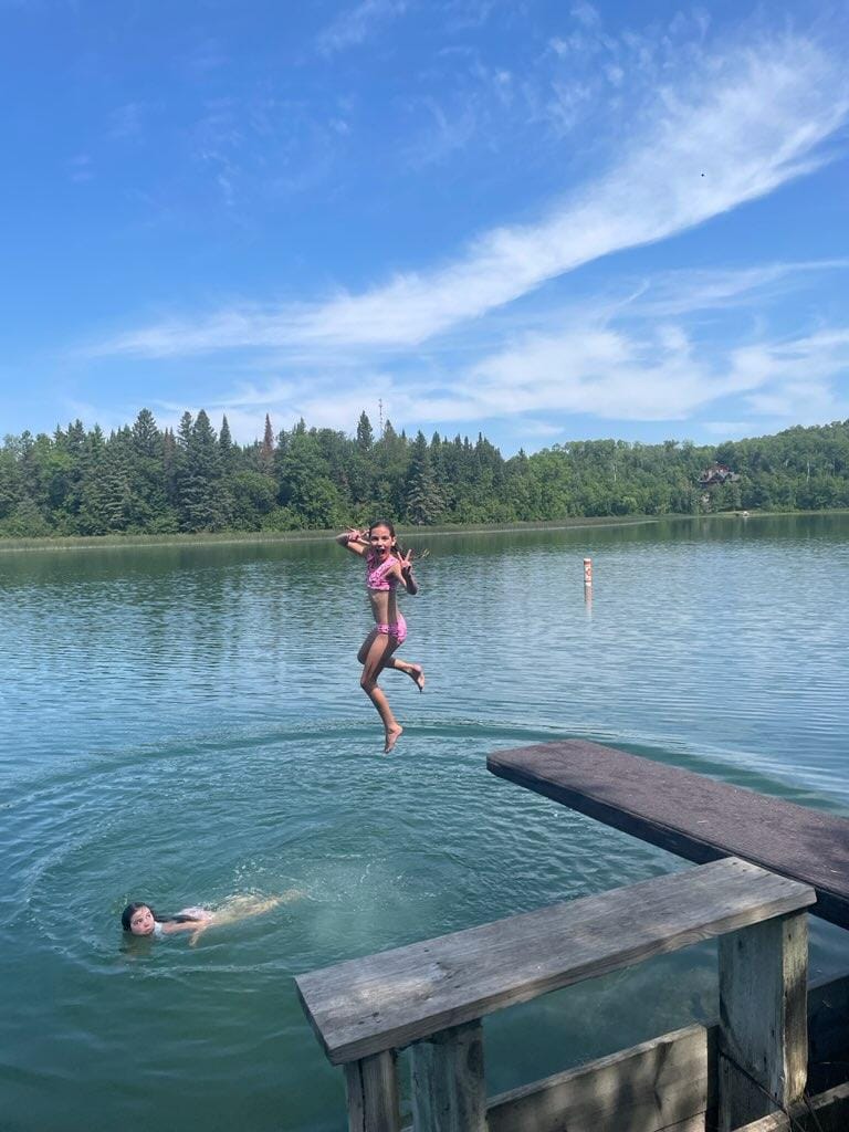 Girl jumping off diving board at Jolly Fisherman Resort