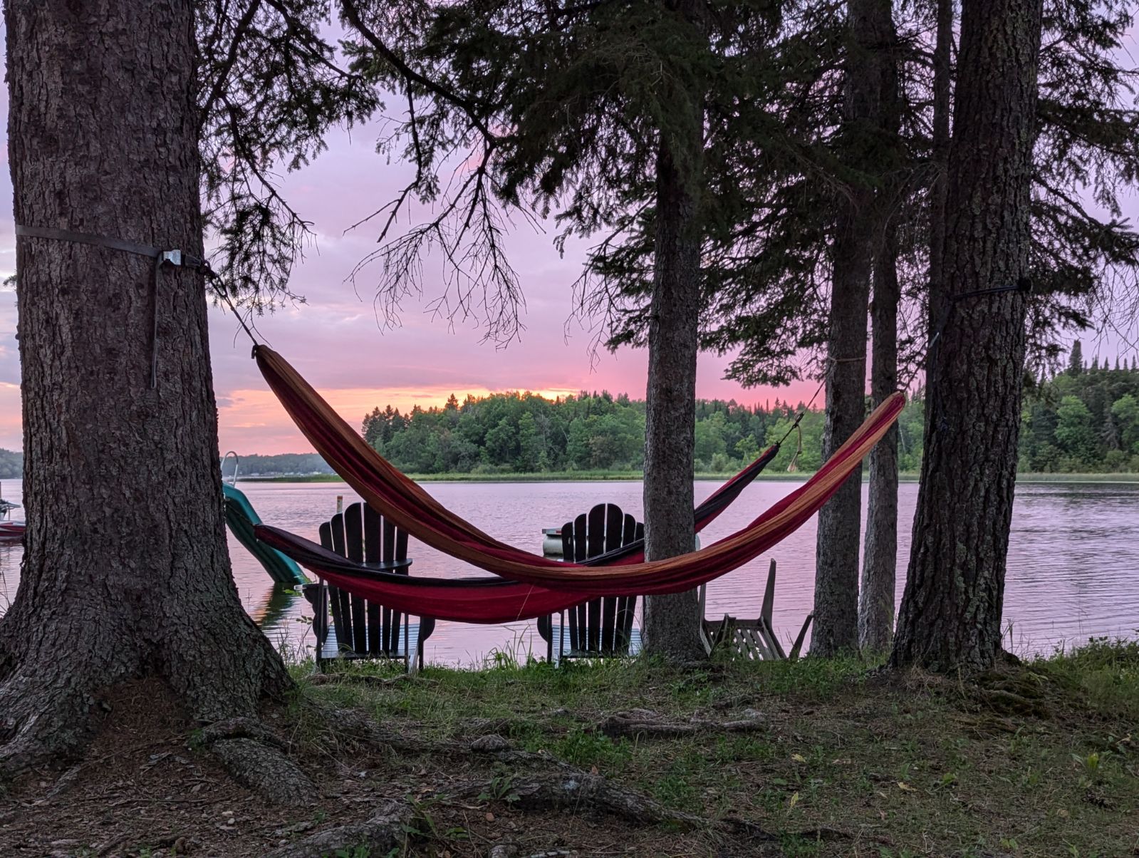 Hammocks swaying in the wind next to the lake